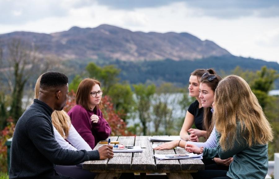 Students sitting at bench